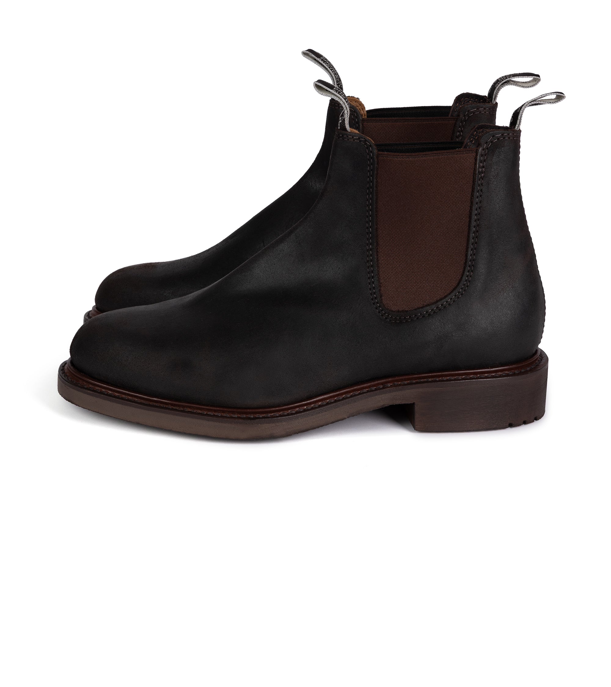 Black leather Chelsea boots with brown accents on a white background